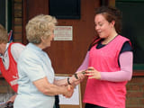A woman being given an award